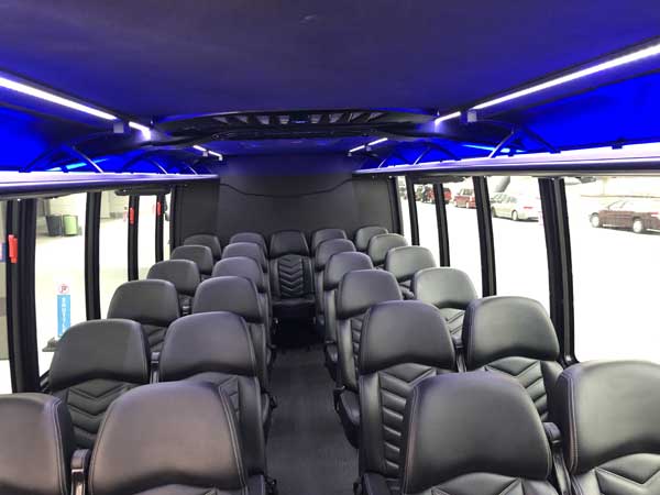 view of the seats of the mini bus taken from the front of the bus